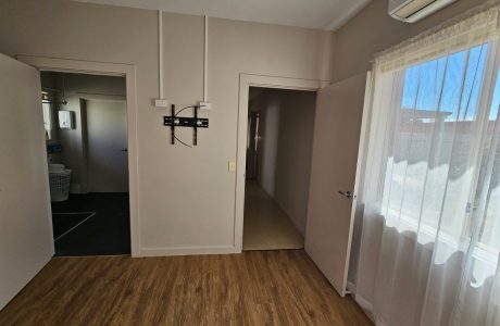 bedroom view to shared bathroom and hallway